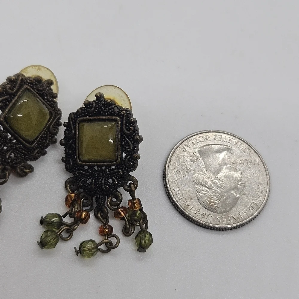 bronze colored earrings with green and orange beading